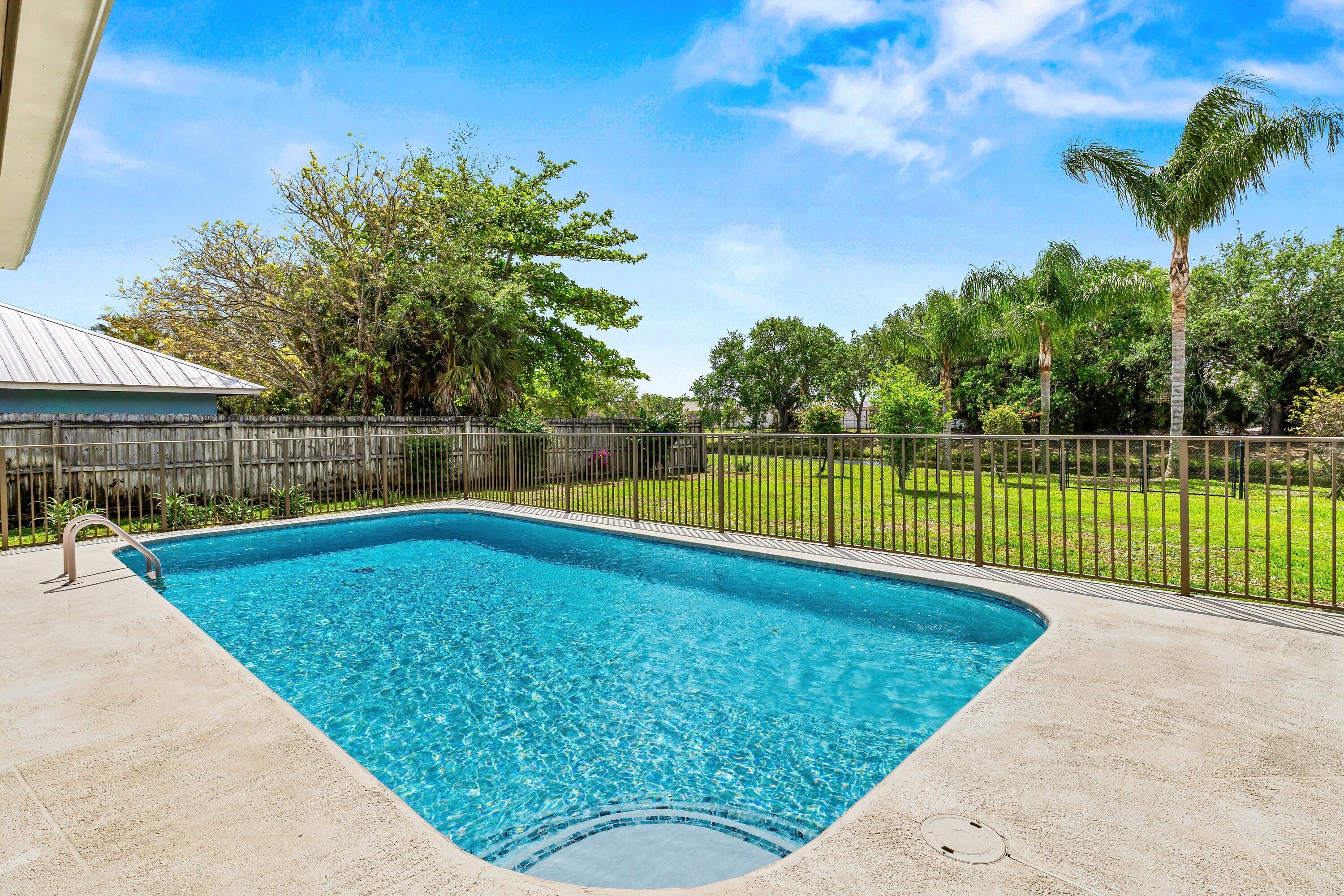 13795 Geranium Place Wellington, FL 33414 - Photo 25 of 37 a view of a backyard with a swimming pool
