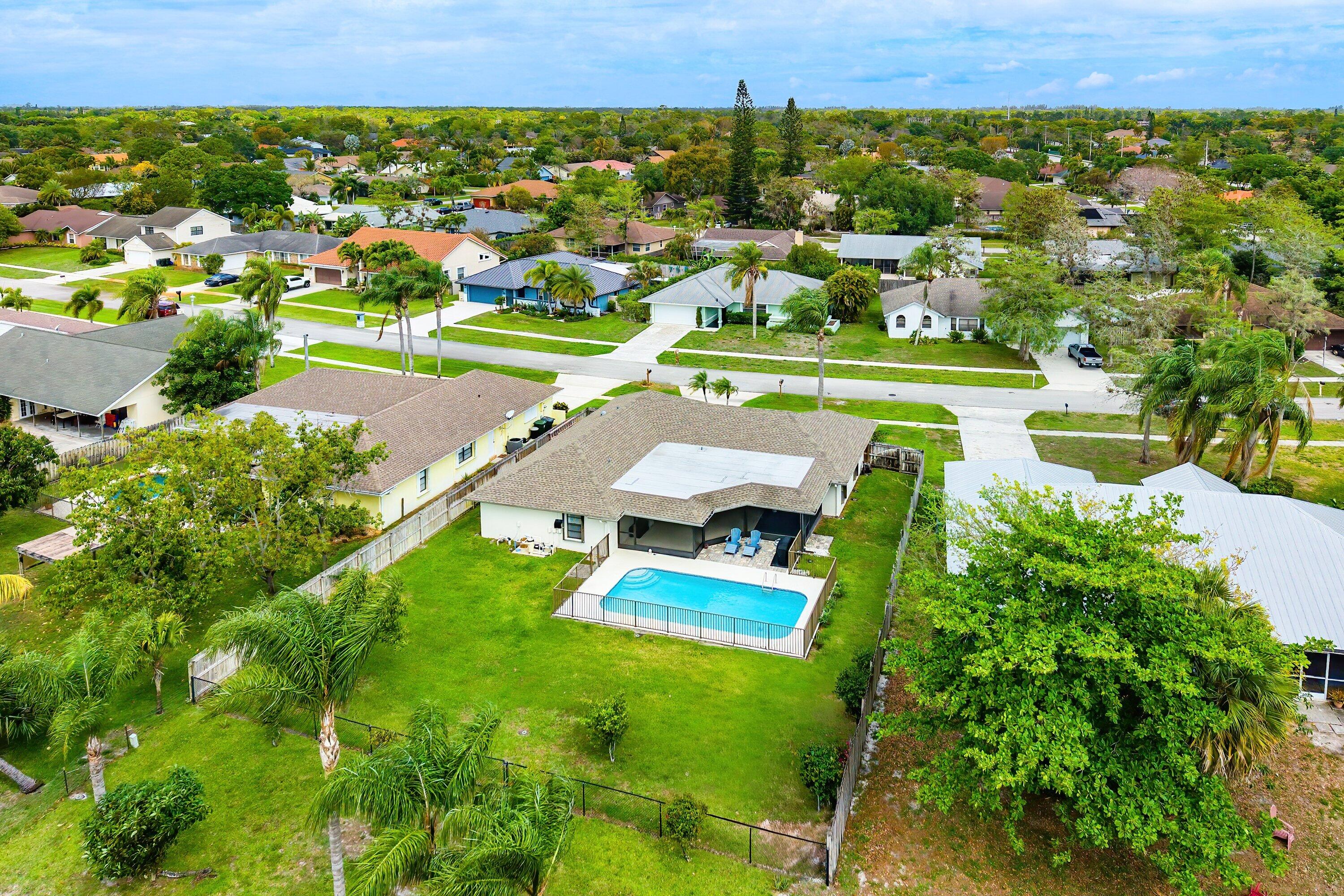 13795 Geranium Place Wellington, FL 33414 - Photo 31 of 37 an aerial view of residential houses with outdoor space and street view