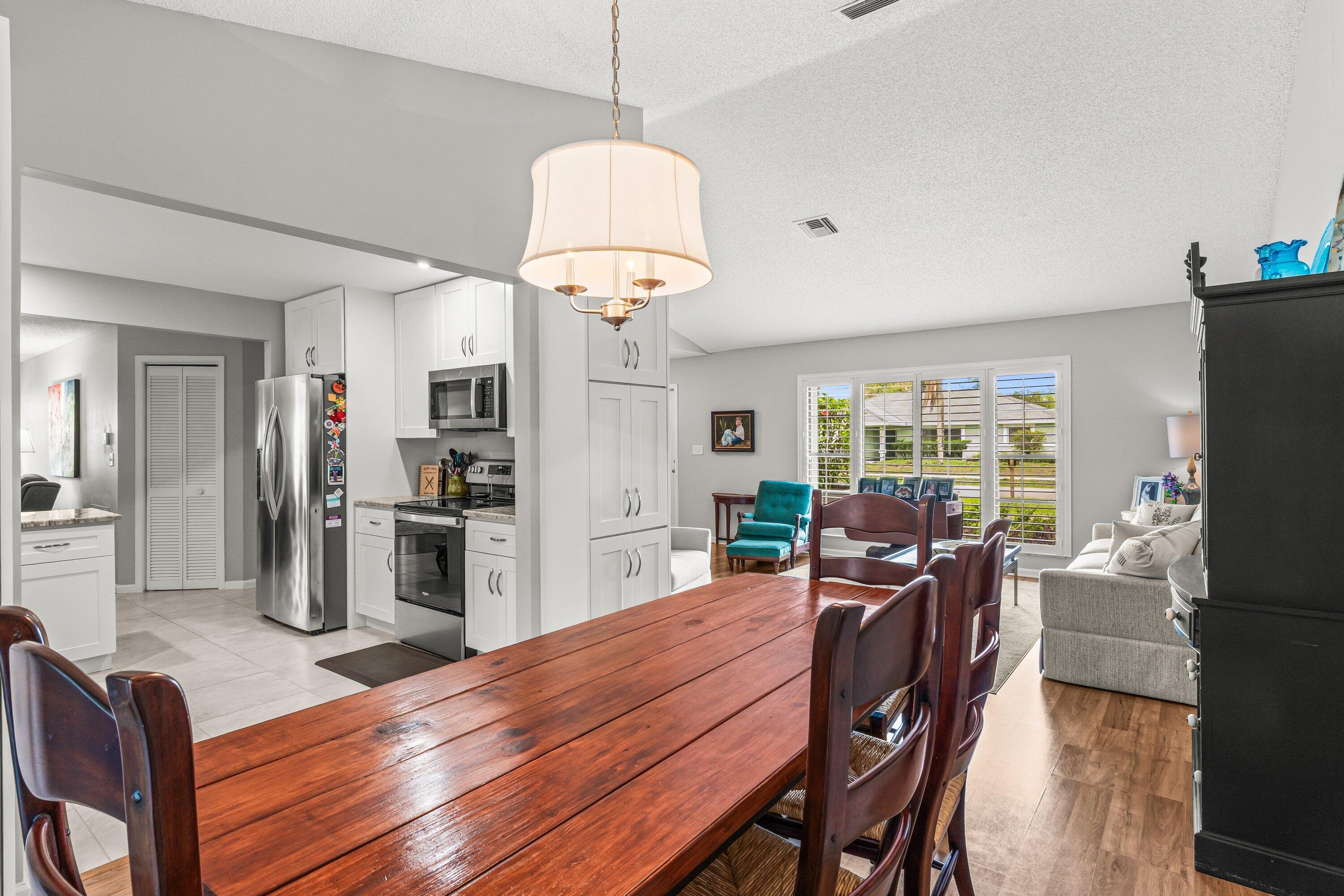 13795 Geranium Place Wellington, FL 33414 - Photo 7 of 37 a view of a dining room with furniture window and wooden floor