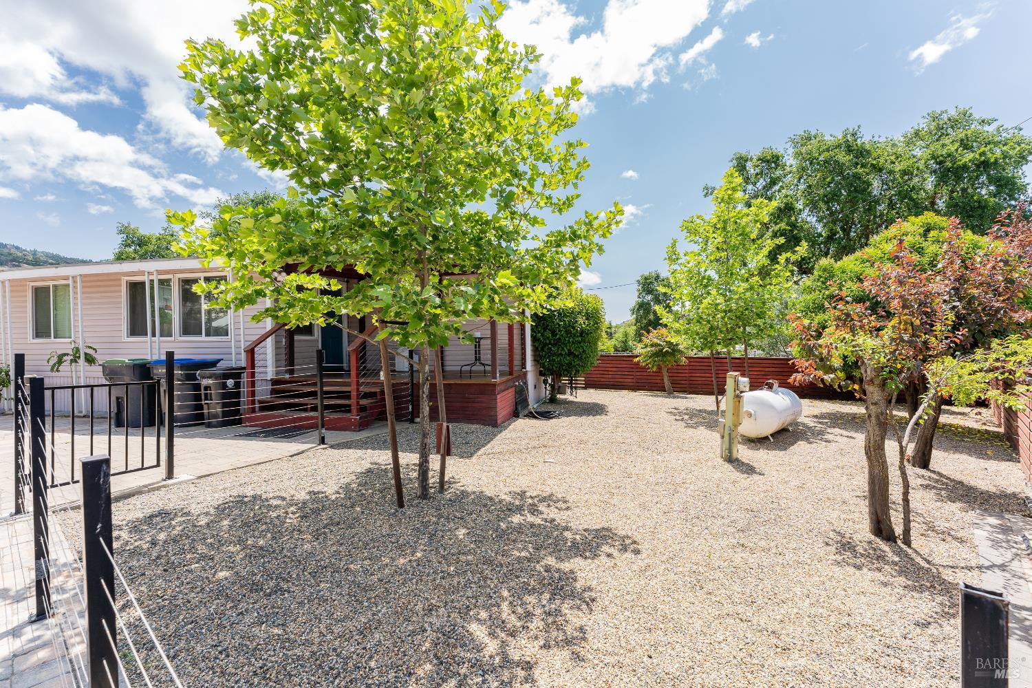 a view of a backyard with sitting area