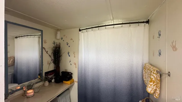 a bathroom with a shower and a sink