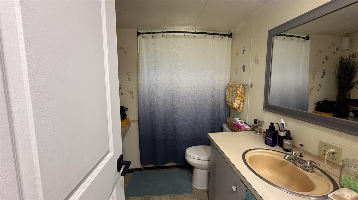 4532 Pine Street Lucerne, CA 95458 - Photo 19 of 34 a bathroom with a sink a toilet and a mirror