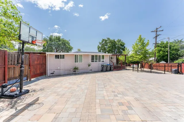 a view of a house with backyard and sitting area