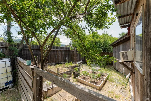 a view of a backyard with chairs and a patio