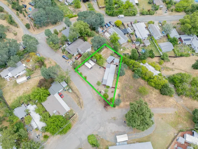 an aerial view of a house with a yard and garden