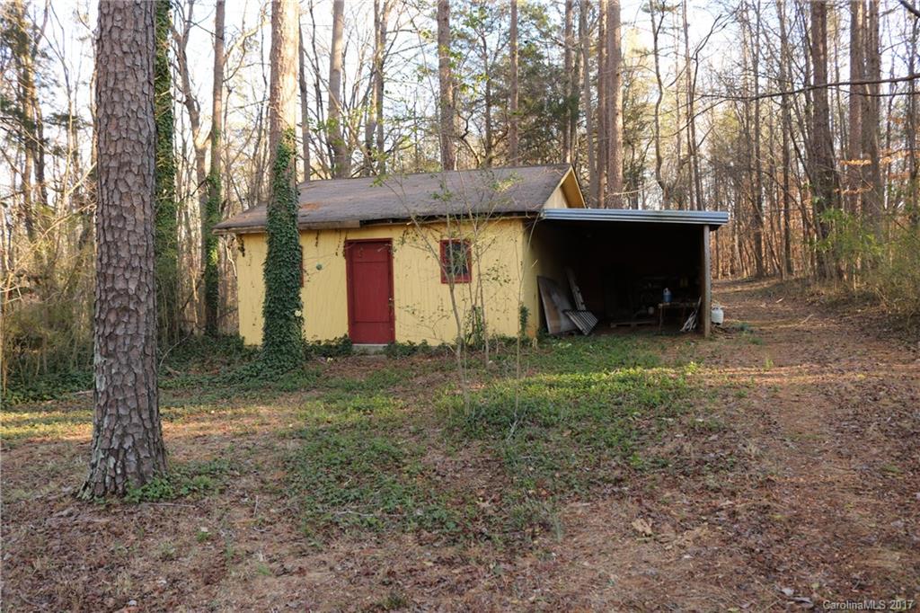 14475 Cabarrus Station Road Midland, NC 28107 - Photo 2 of 23 a view of a house with backyard and trees