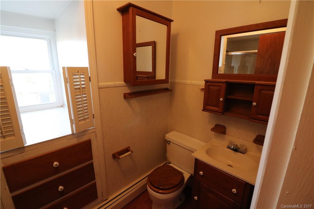 14475 Cabarrus Station Road Midland, NC 28107 - Photo 14 of 23 a bathroom with a toilet a sink and a mirror