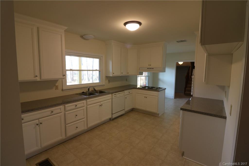 14475 Cabarrus Station Road Midland, NC 28107 - Photo 17 of 23 a large kitchen with white cabinets and a sink