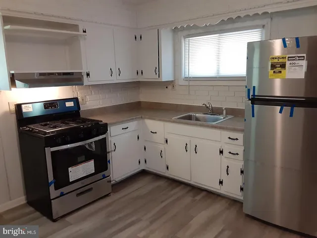 a kitchen with appliances cabinets and a window