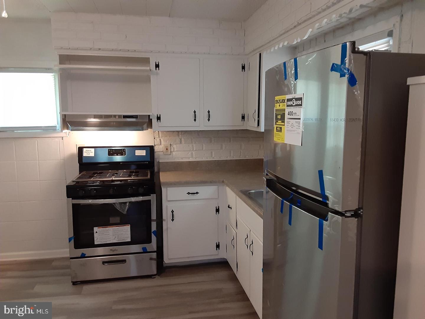 209 Baldwin Road Glassboro, NJ 08028 - Photo 5 of 10 a kitchen with a refrigerator stove and white cabinets