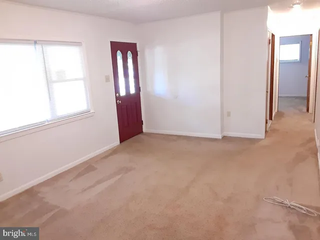 an empty room with windows and closet