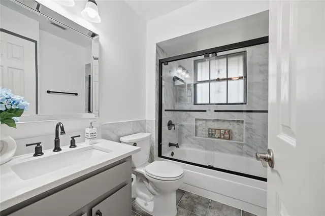 a bathroom with a sink a toilet and a mirror