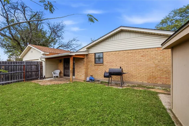 a view of a house with a yard and sitting area