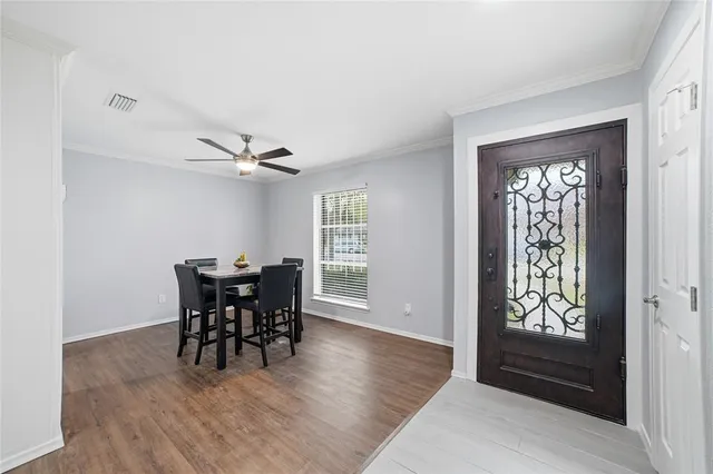 a view of a dining room with furniture and wooden floor