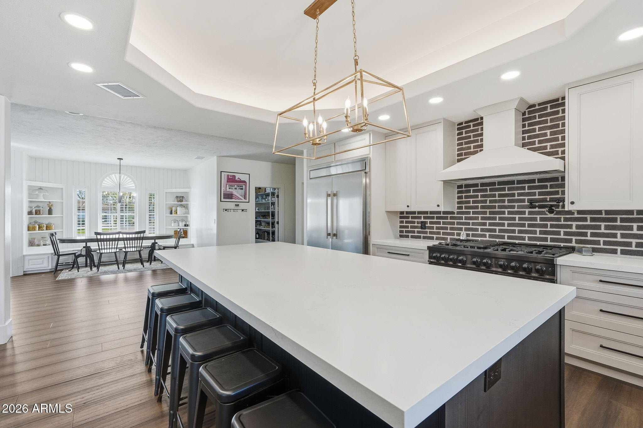 4222 East McLellan Road, Unit 15 Mesa, AZ 85205 - Photo 21 of 86 a kitchen with a table chairs and wooden floor