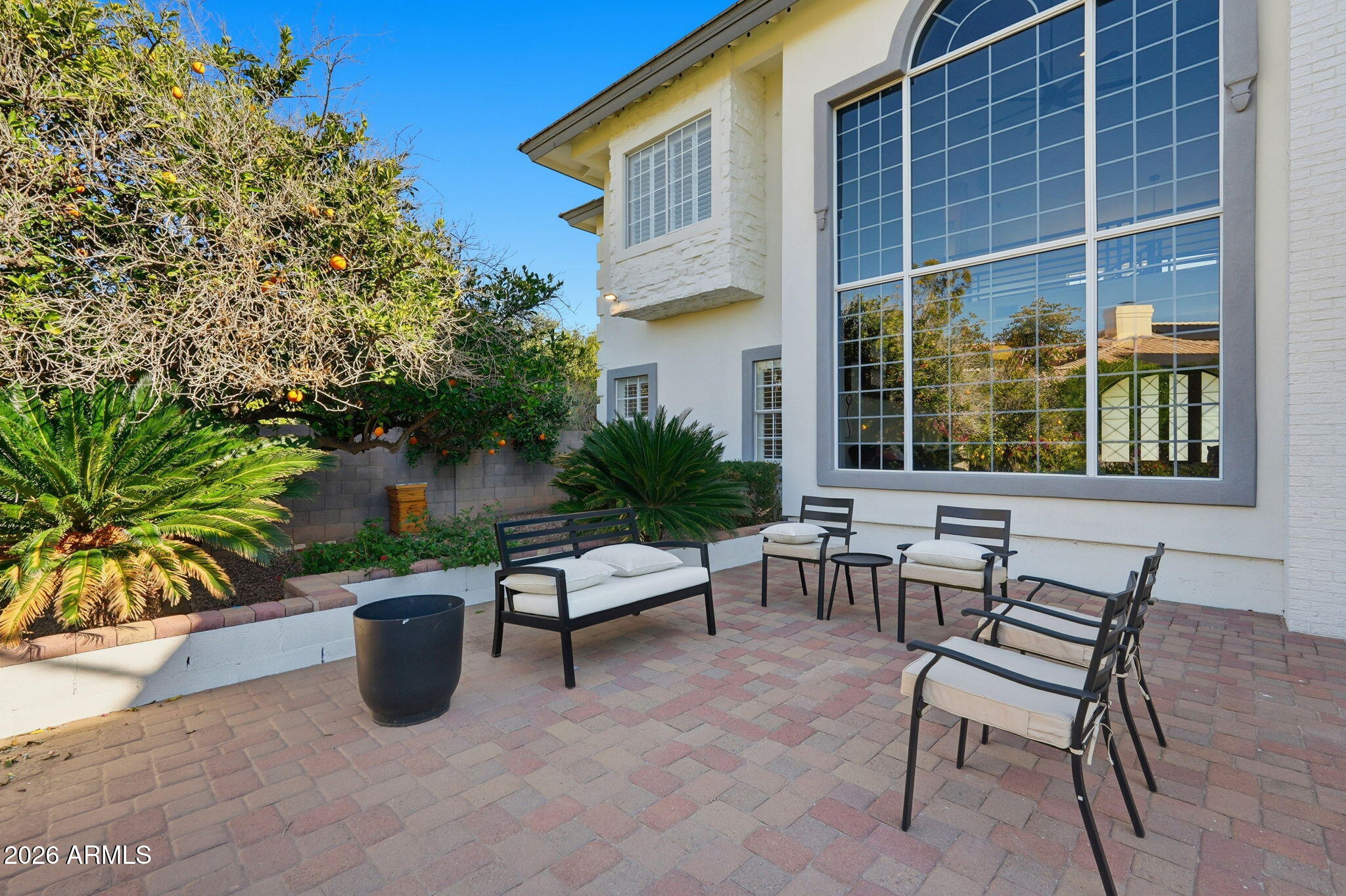 4222 East McLellan Road, Unit 15 Mesa, AZ 85205 - Photo 67 of 86 a view of a patio with table and chairs and potted plants