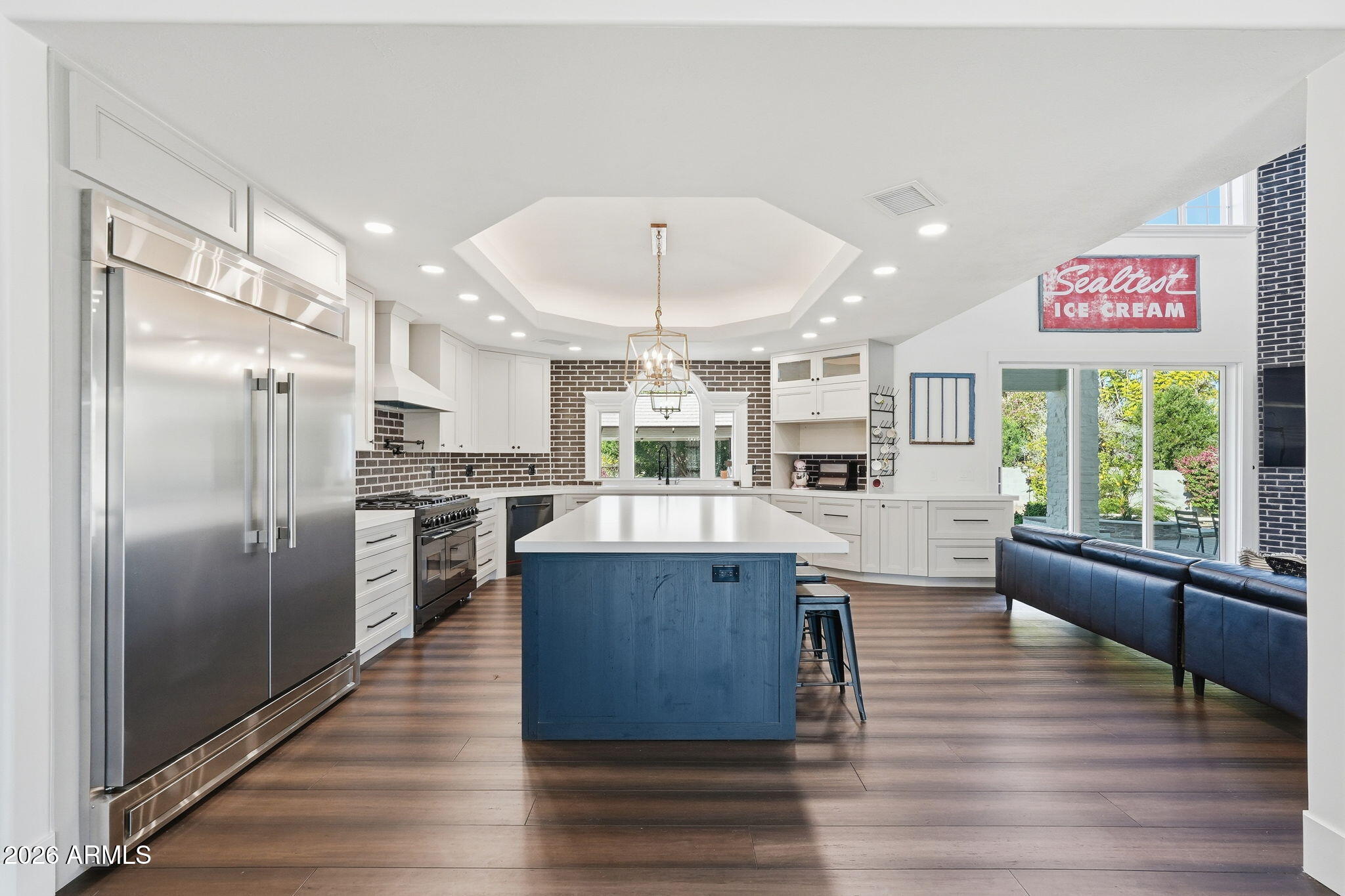 4222 East McLellan Road, Unit 15 Mesa, AZ 85205 - Photo 10 of 86 a kitchen with stainless steel appliances kitchen island granite countertop a refrigerator a stove a sink dishwasher and a dining table with wooden floor