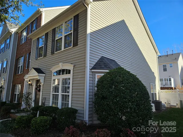 a view of a house with a yard and plants