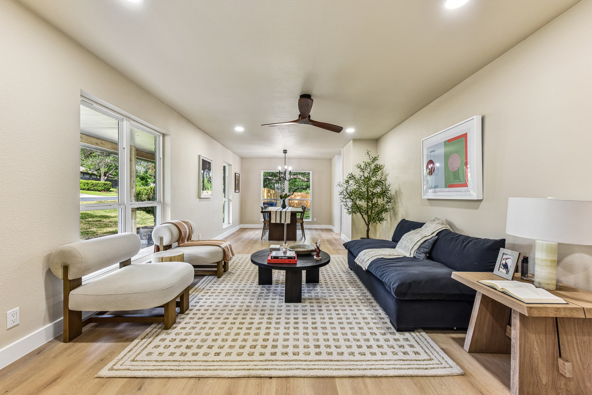 7523 Glenhill Road Austin, TX 78752 - Photo 6 of 38 A naturally illuminated living area with hardwood floors, recessed lighting, and large windows offers comfortable gathering space.