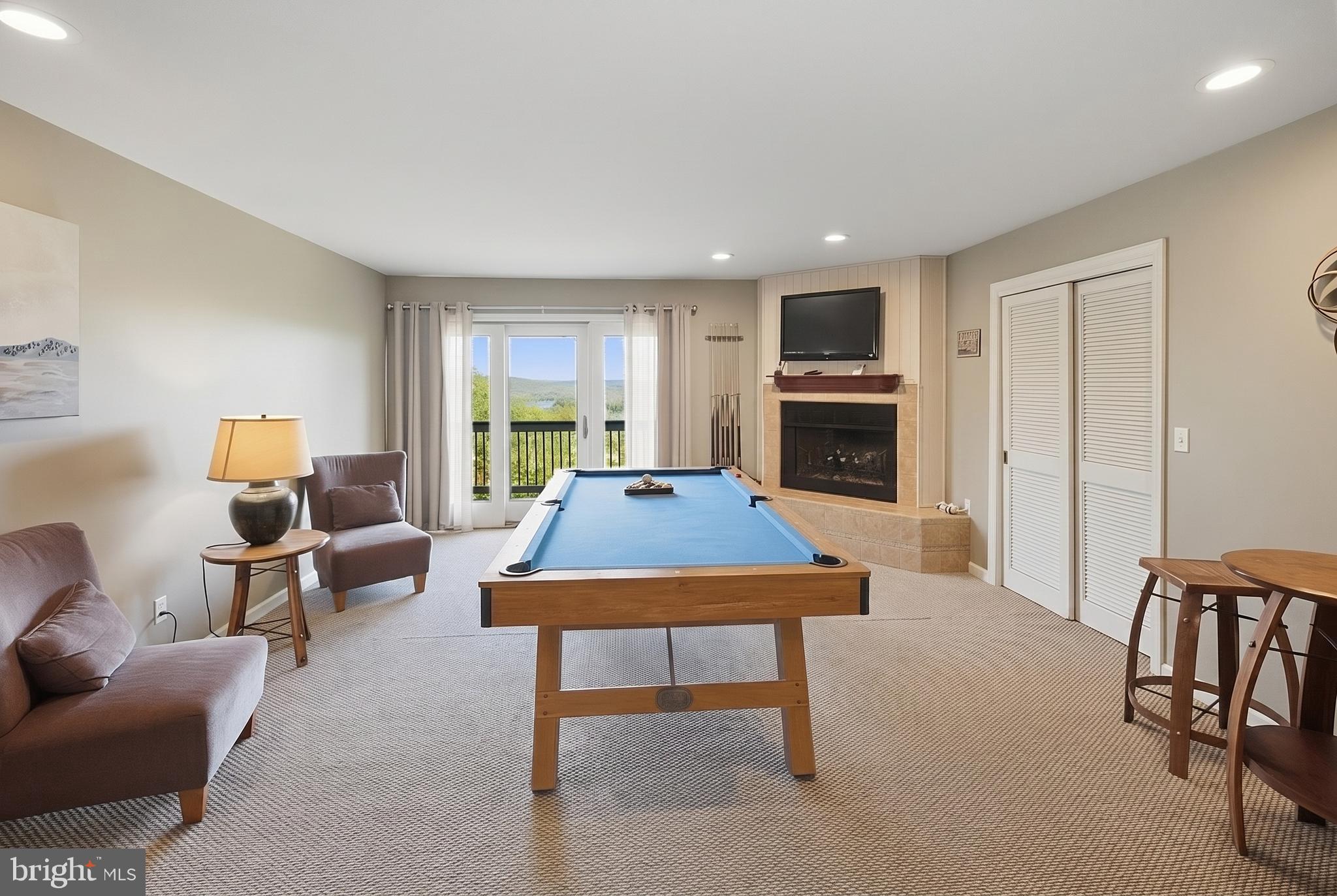 467 Paradise Ridge Road Oakland, MD 21550 - Photo 26 of 64 a living room with furniture a flat screen tv and a fireplace