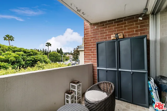 a view of a balcony and yard with furniture
