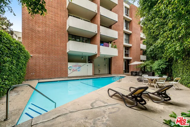 a view of backyard with outdoor seating and plants
