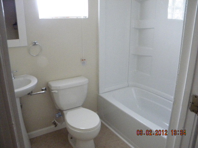 5331 Twilight Road Roanoke, VA 24019 - Photo 8 of 14 a white toilet sitting next to a bath tub