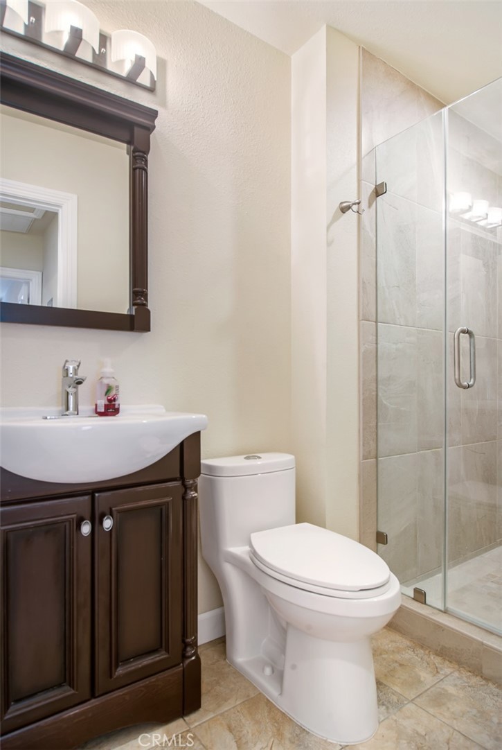 7192 9th Street Buena Park, CA 90621 - Photo 17 of 24 a bathroom with a sink a toilet and shower