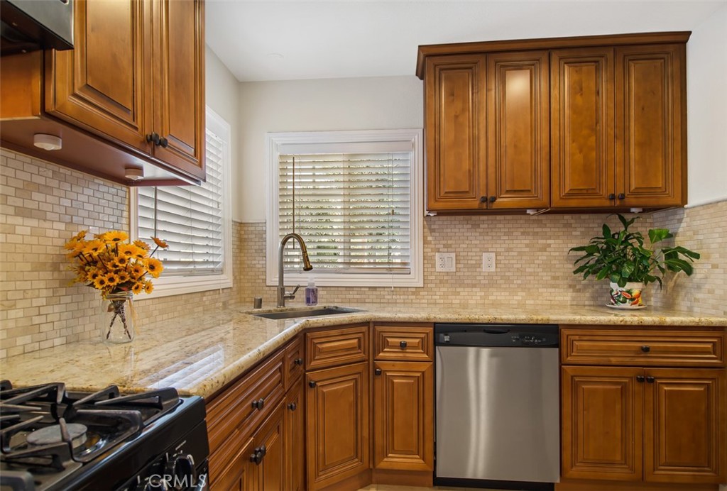 7192 9th Street Buena Park, CA 90621 - Photo 8 of 24 a kitchen with granite countertop cabinets and window