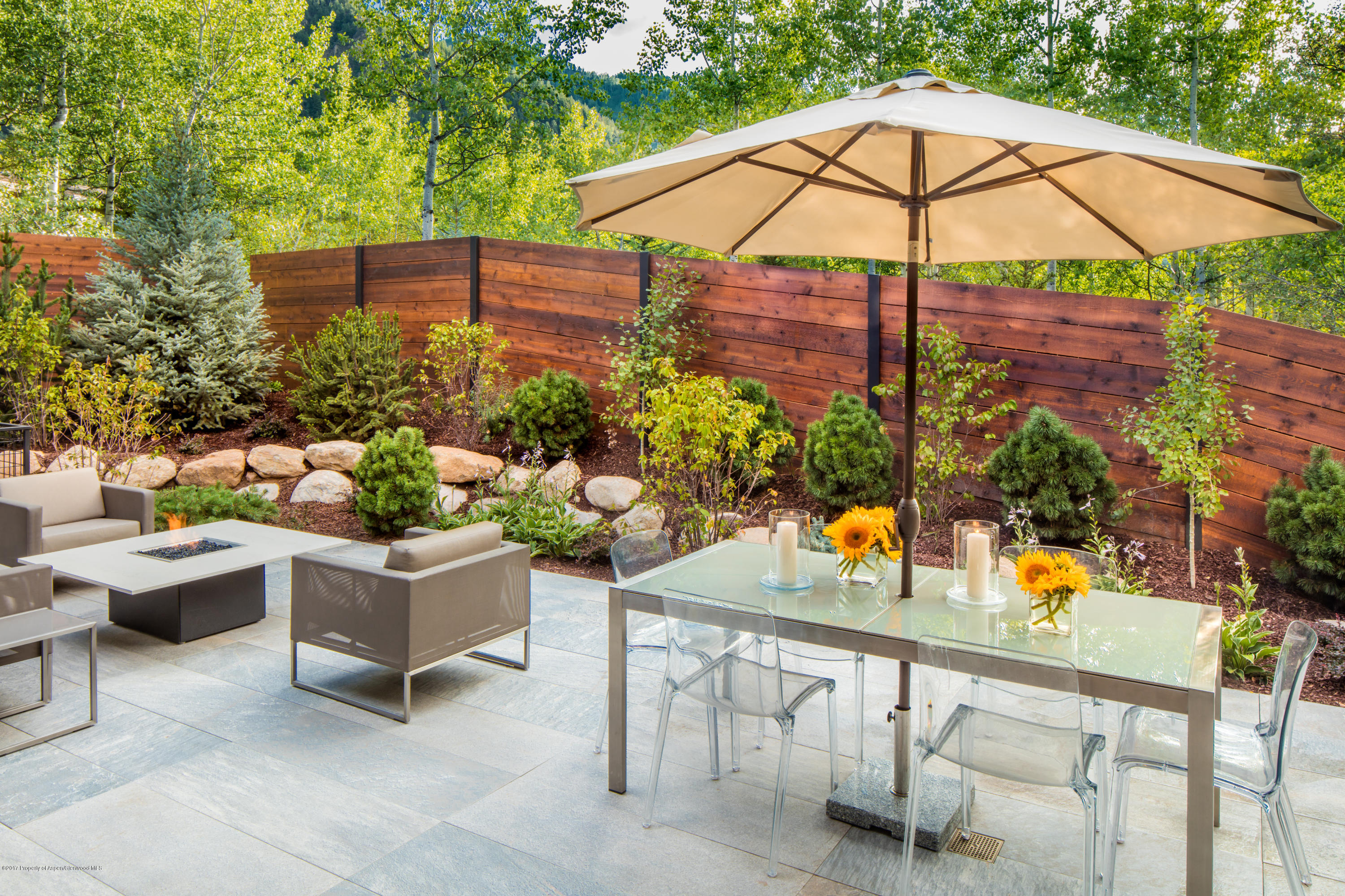 1195 Riverside Drive Aspen, CO 81611 - Photo 17 of 19 a view of a patio with couches and potted plants