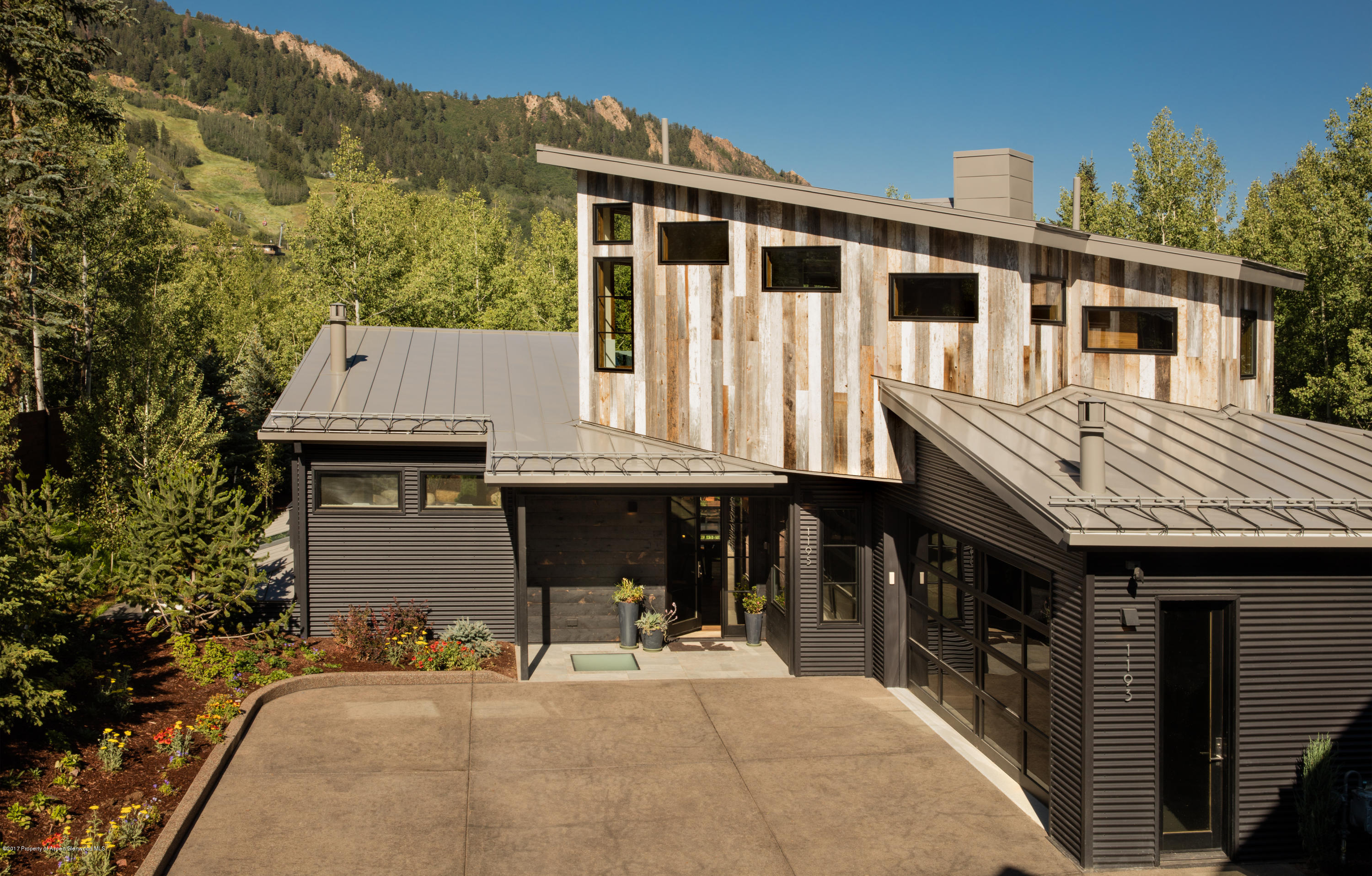 1195 Riverside Drive Aspen, CO 81611 - Photo 2 of 19 a front view of a house with a yard and seating space