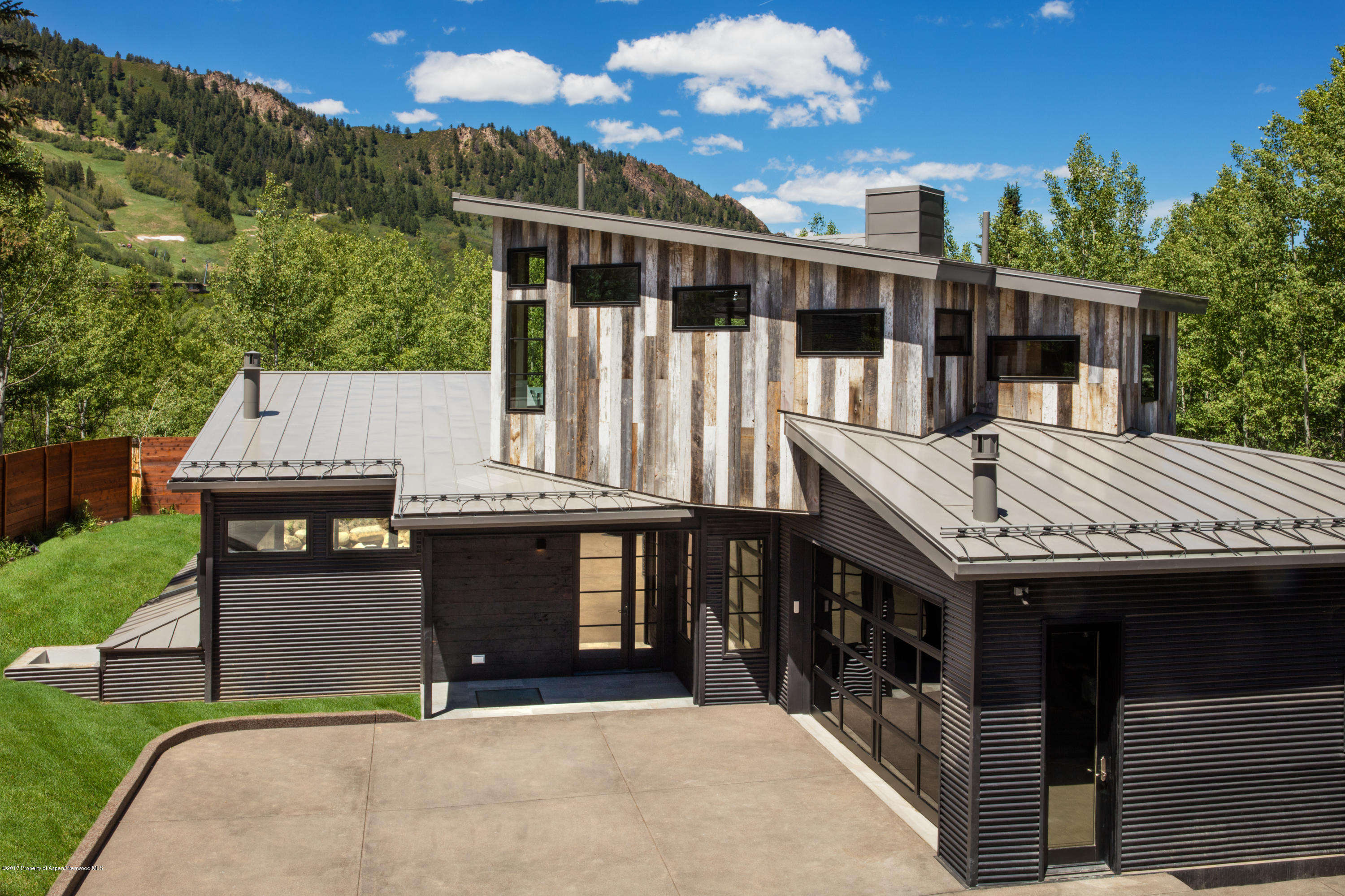 1195 Riverside Drive Aspen, CO 81611 - Photo 3 of 19 a view of house with a swimming pool and sitting area