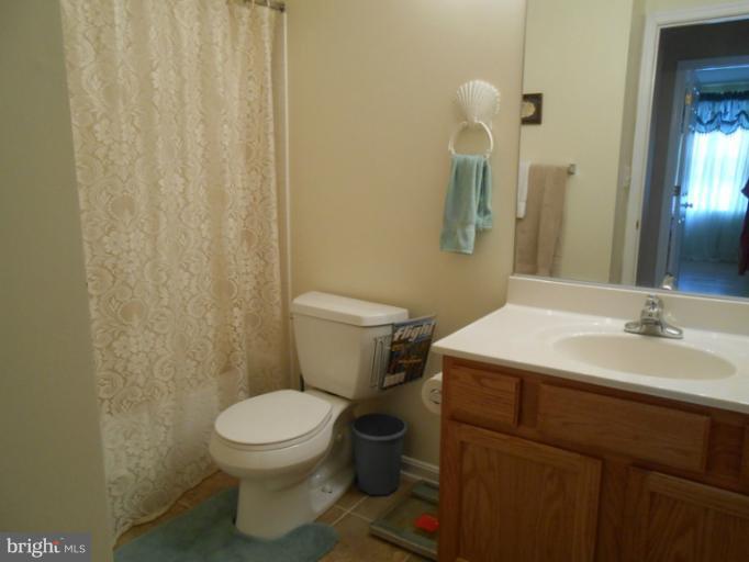 2685 Pheasant Hunt Road Woodbridge, VA 22192 - Photo 13 of 24 a bathroom with a sink a toilet and a mirror