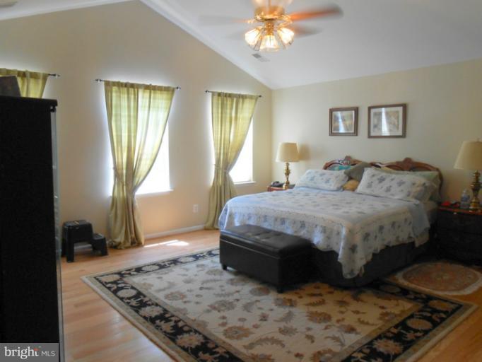 2685 Pheasant Hunt Road Woodbridge, VA 22192 - Photo 19 of 24 a bedroom with a bed and wooden floor