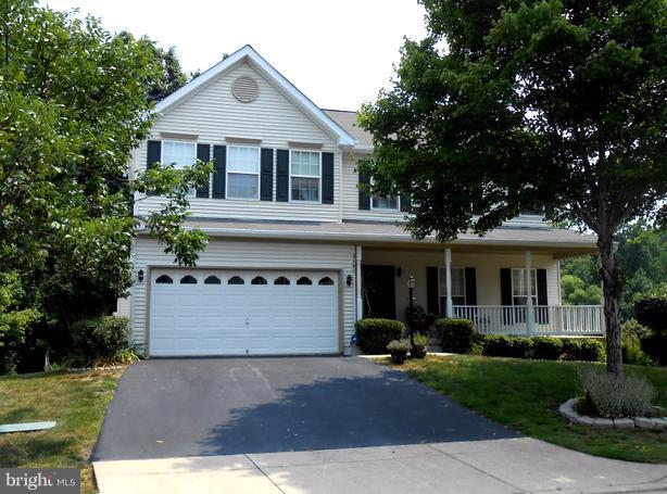 2685 Pheasant Hunt Road Woodbridge, VA 22192 - Photo 24 of 24 a front view of a house with a yard and garage