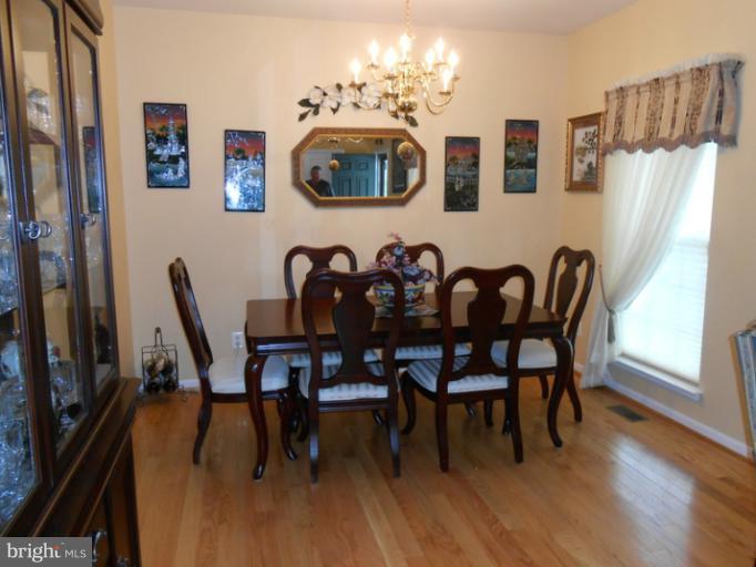 2685 Pheasant Hunt Road Woodbridge, VA 22192 - Photo 4 of 24 a view of a dining room with furniture and wooden floor