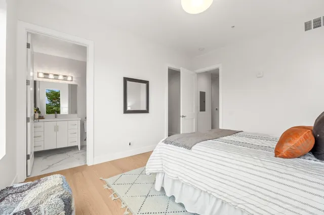 a bedroom with a large bed and a chandelier