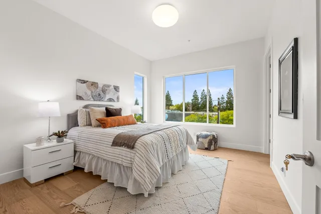 a bedroom with a bed and a large window