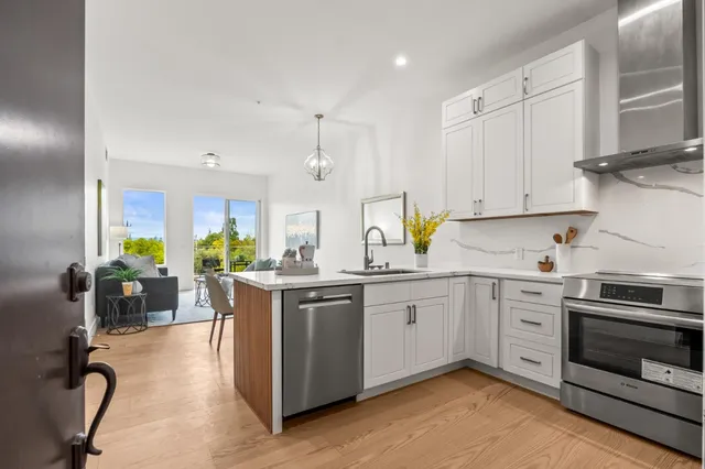 a kitchen with a sink appliances and cabinets