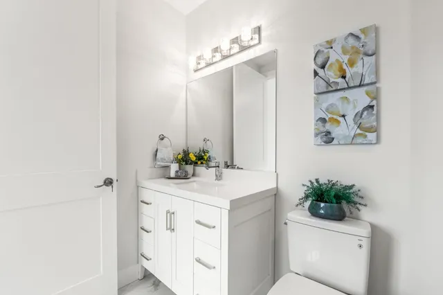a bathroom with a sink a toilet and mirror