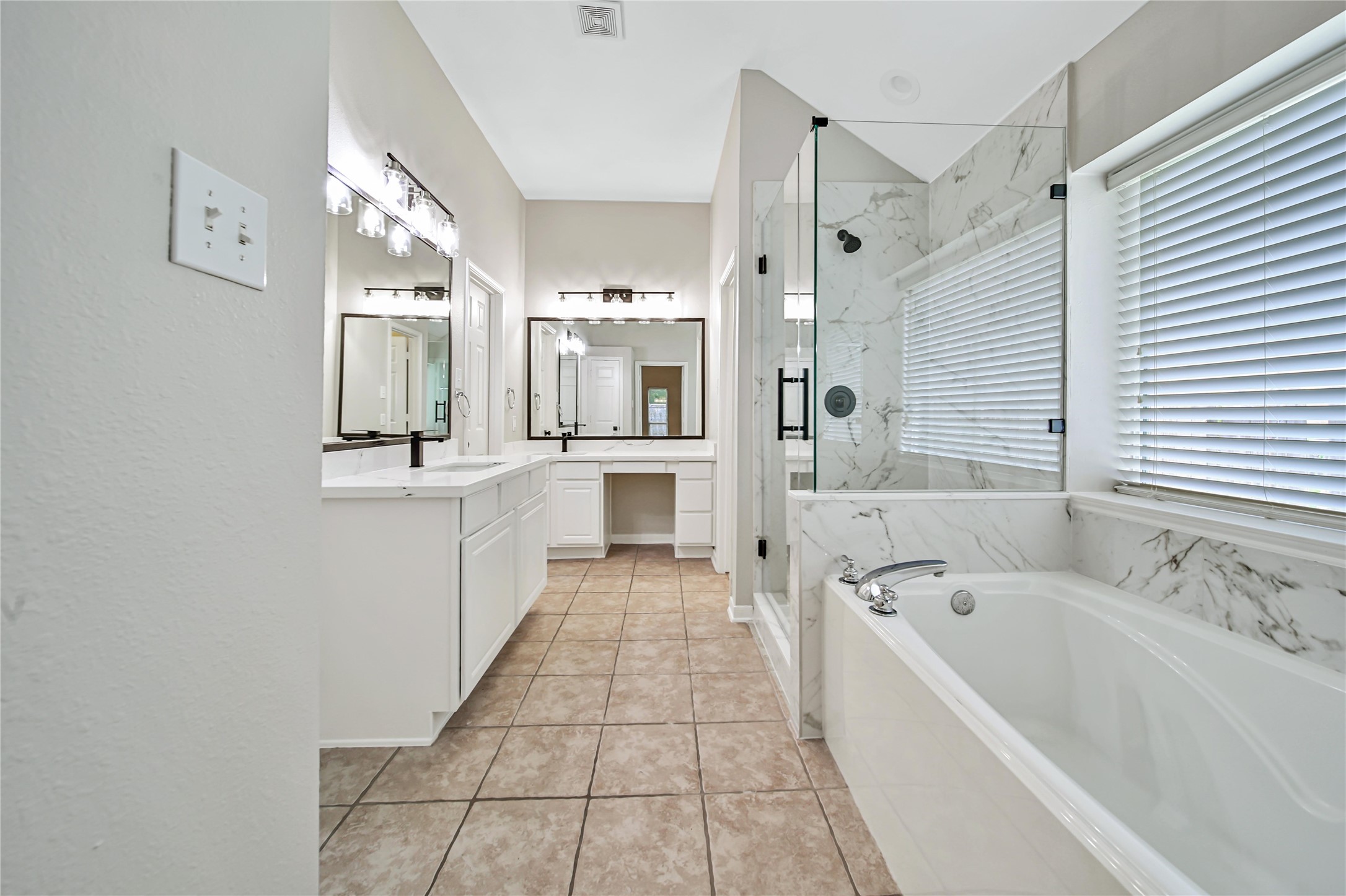 14526 Red Tailed Hawk Lane Houston, TX 77044 - Photo 21 of 40 a large bathroom with a tub a sink a mirror and a shower
