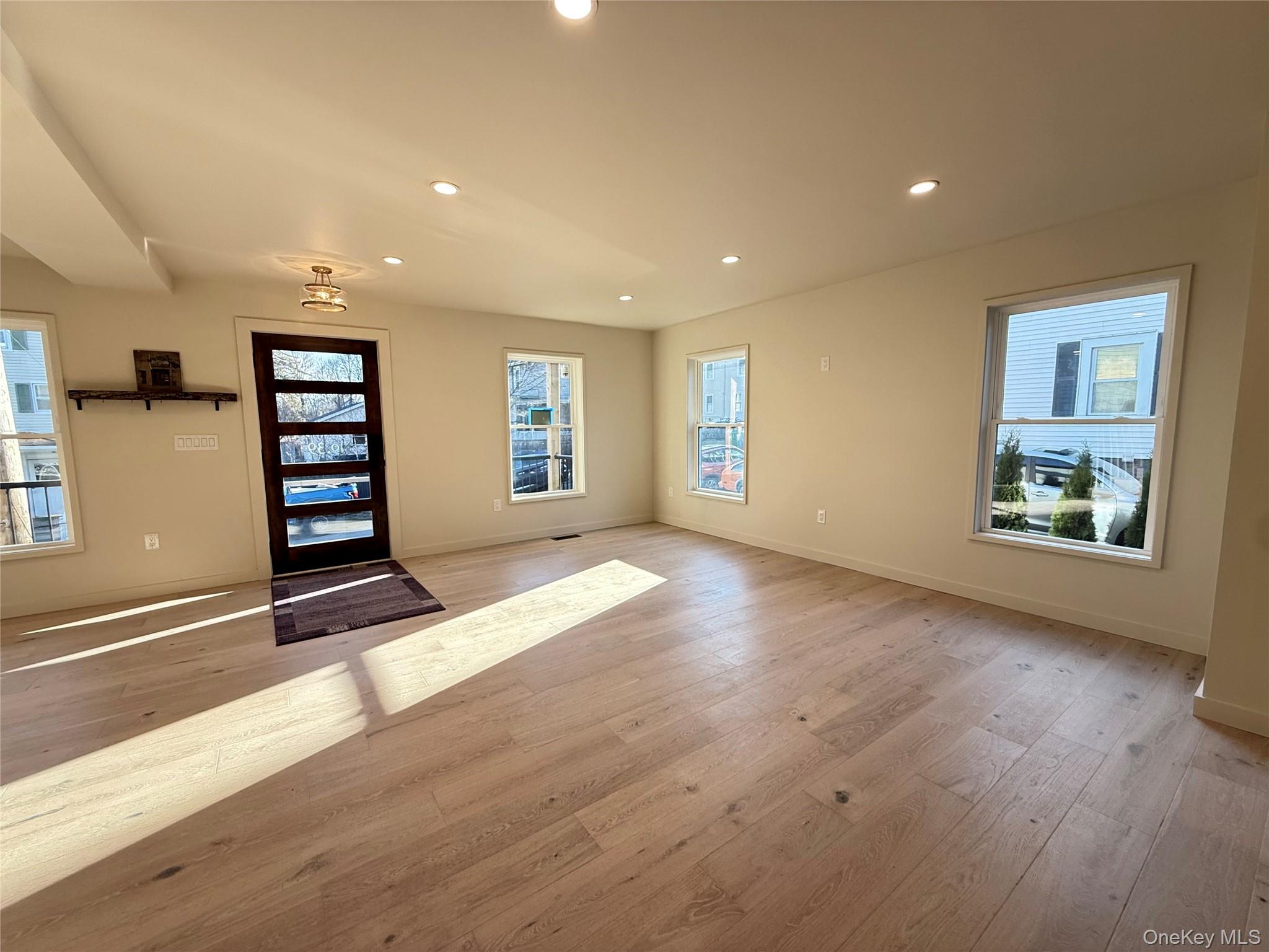 39 Falconer Street Beacon, NY 12508 - Photo 17 of 49 a view of an empty room with a window and wooden floor