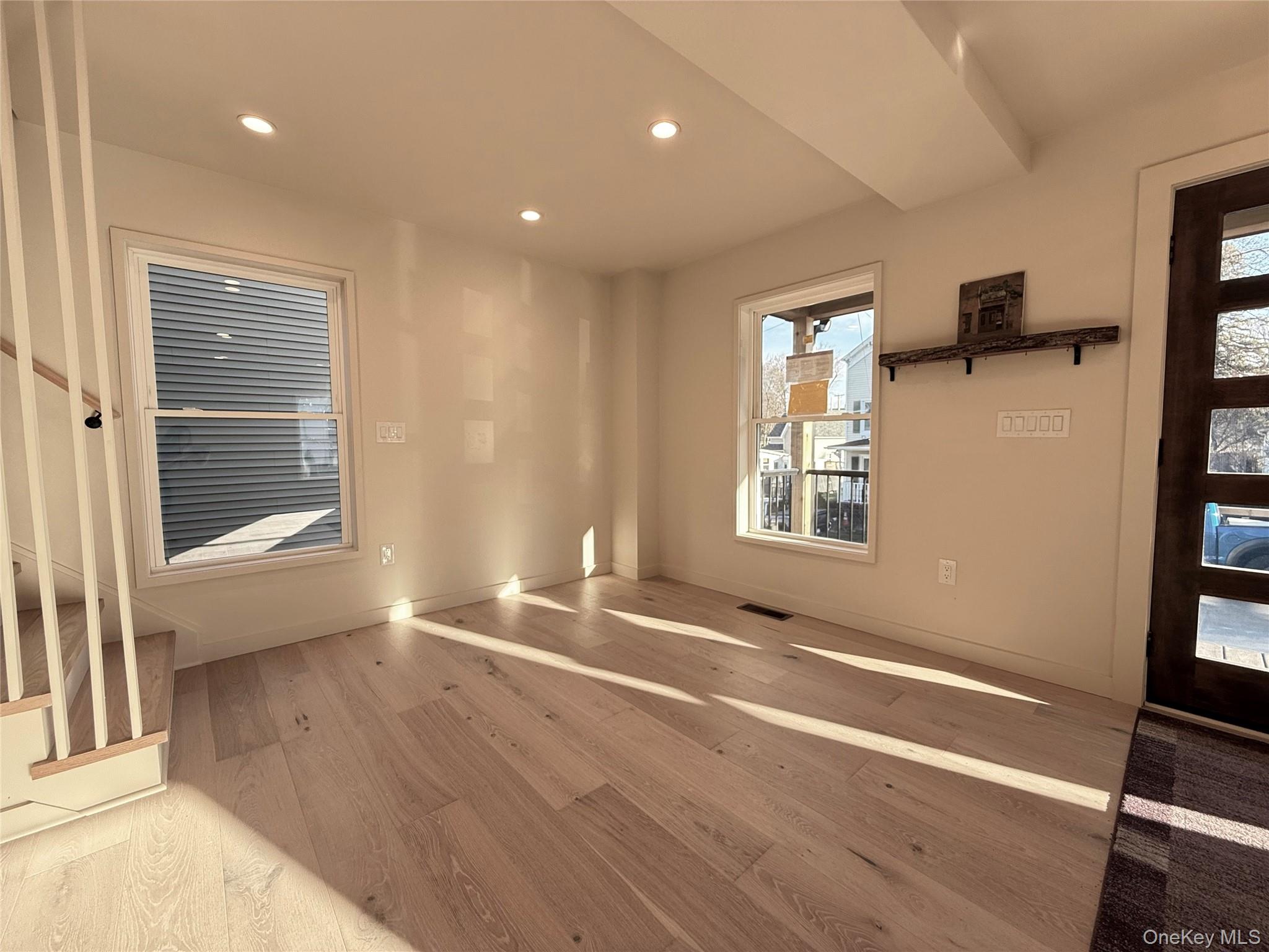 39 Falconer Street Beacon, NY 12508 - Photo 18 of 49 a view of an empty room with a window and wooden floor
