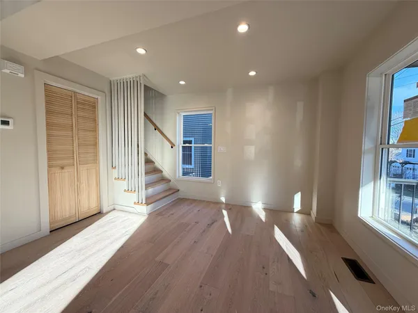 a view of entryway with wooden floor and stairs