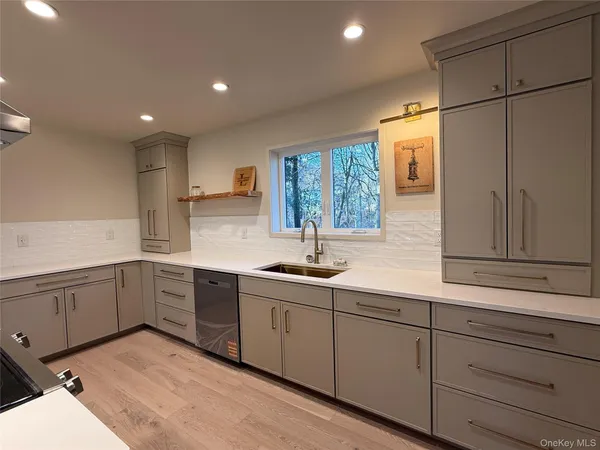 a kitchen with sink cabinets and window