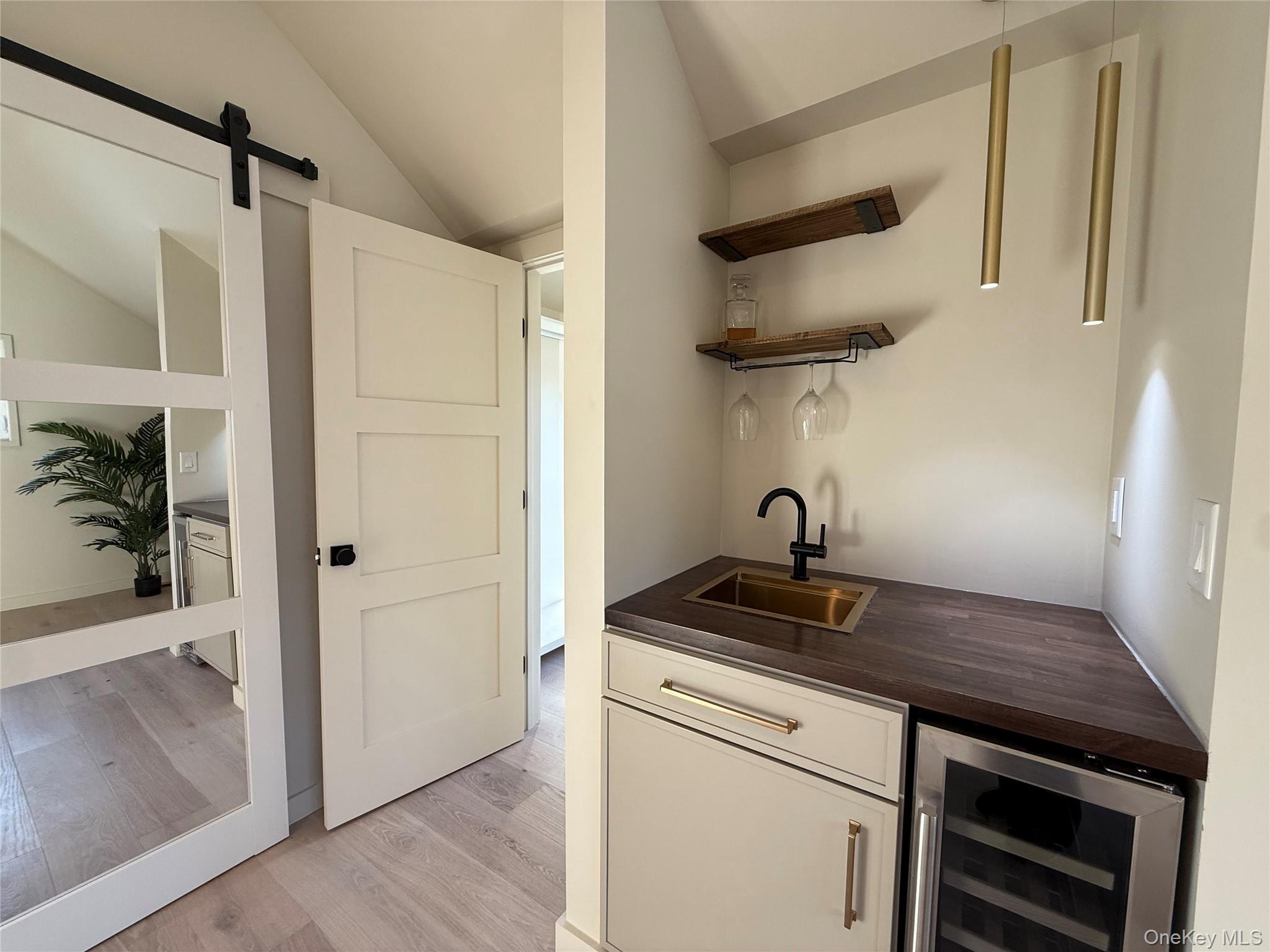 39 Falconer Street Beacon, NY 12508 - Photo 31 of 49 a kitchen with a sink a refrigerator and cabinets