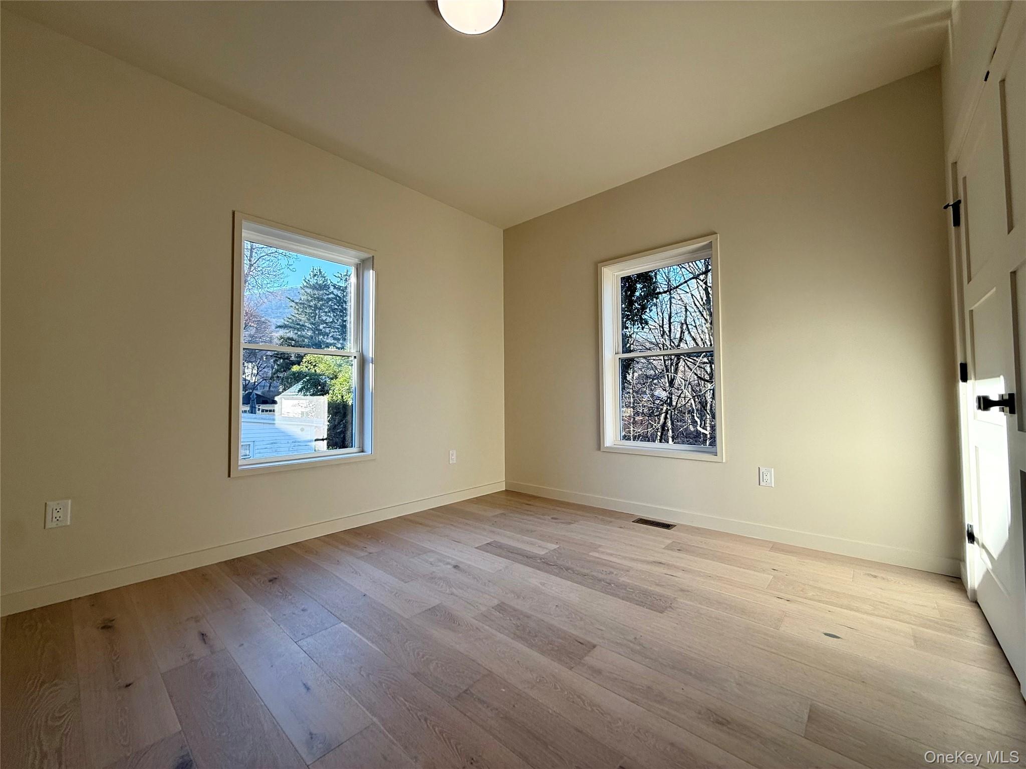 39 Falconer Street Beacon, NY 12508 - Photo 37 of 49 a view of an empty room with window and hardwood floor