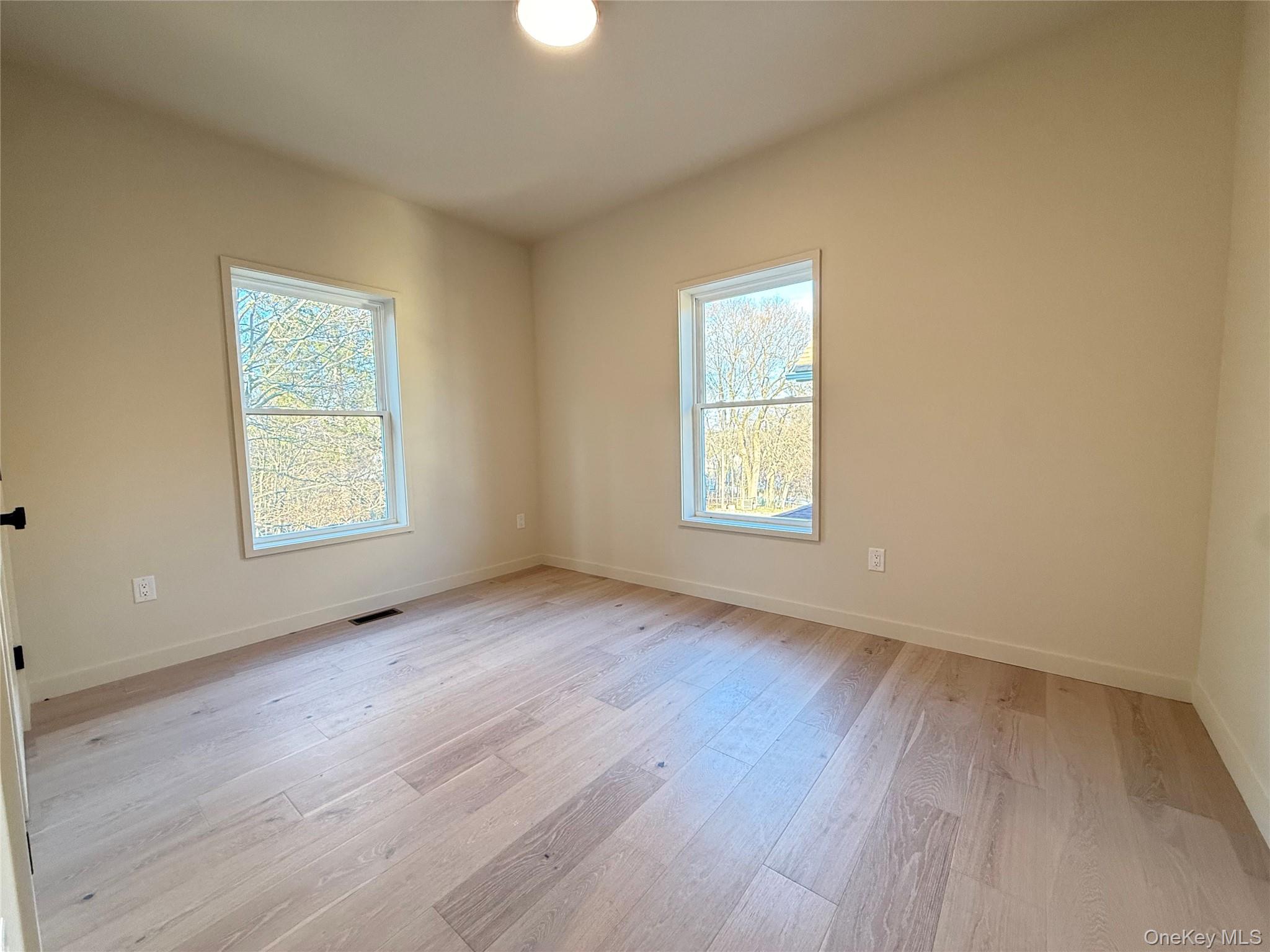 39 Falconer Street Beacon, NY 12508 - Photo 38 of 49 an empty room with wooden floor and windows