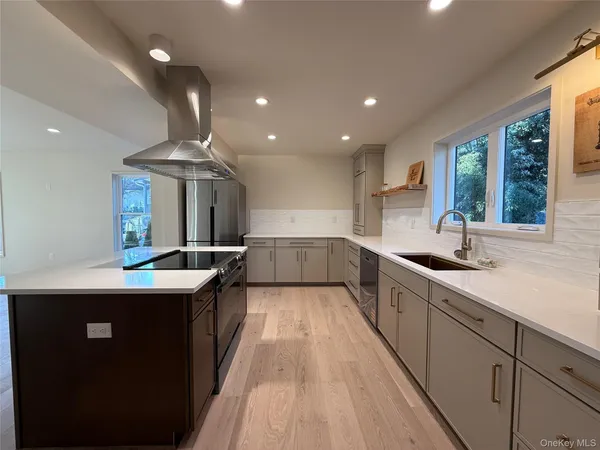 a kitchen with stainless steel appliances a sink stove and cabinets