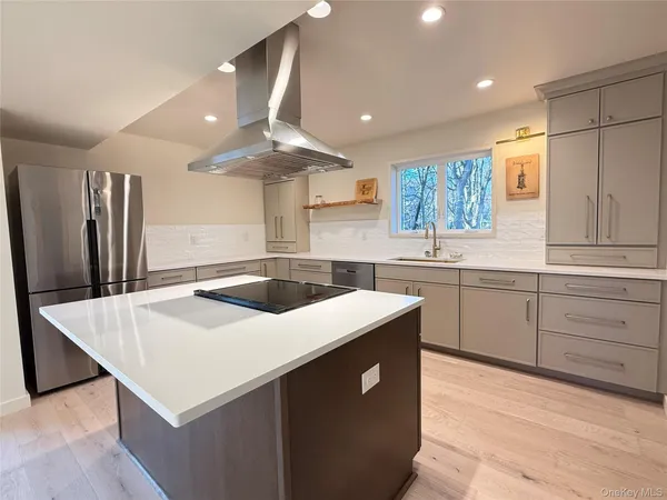 a kitchen with a stove a sink and a refrigerator